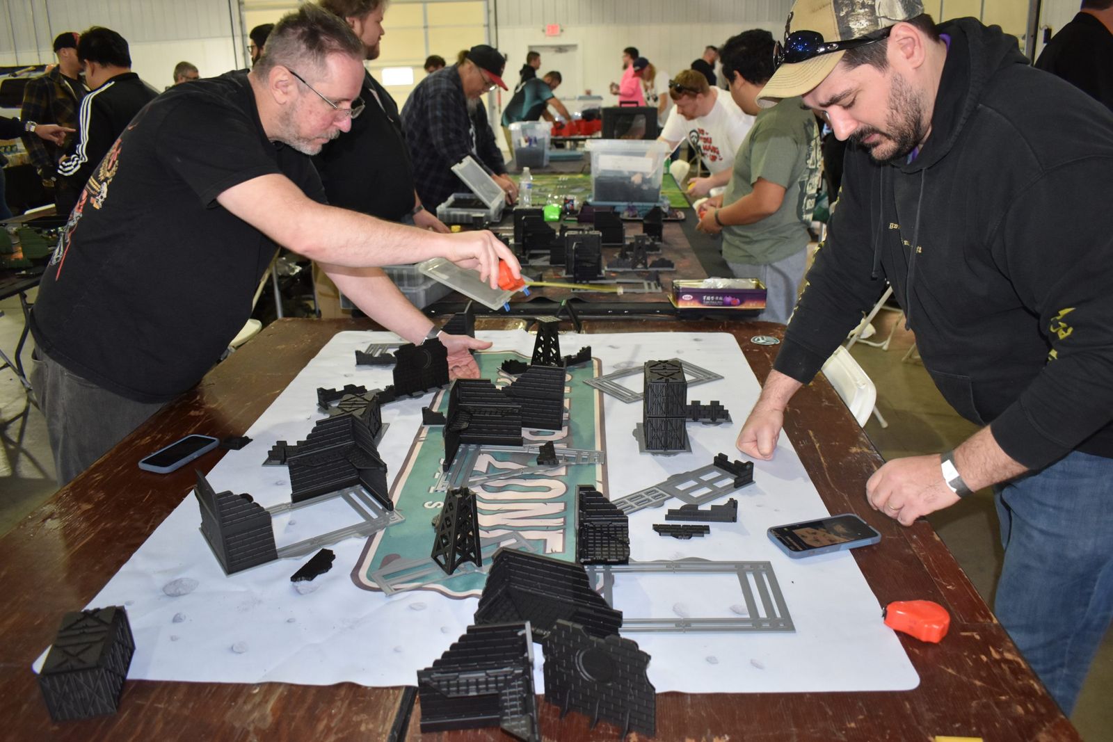 Two players setting up terrain for a Warhammer 40K game on day two of OrktoberFest III